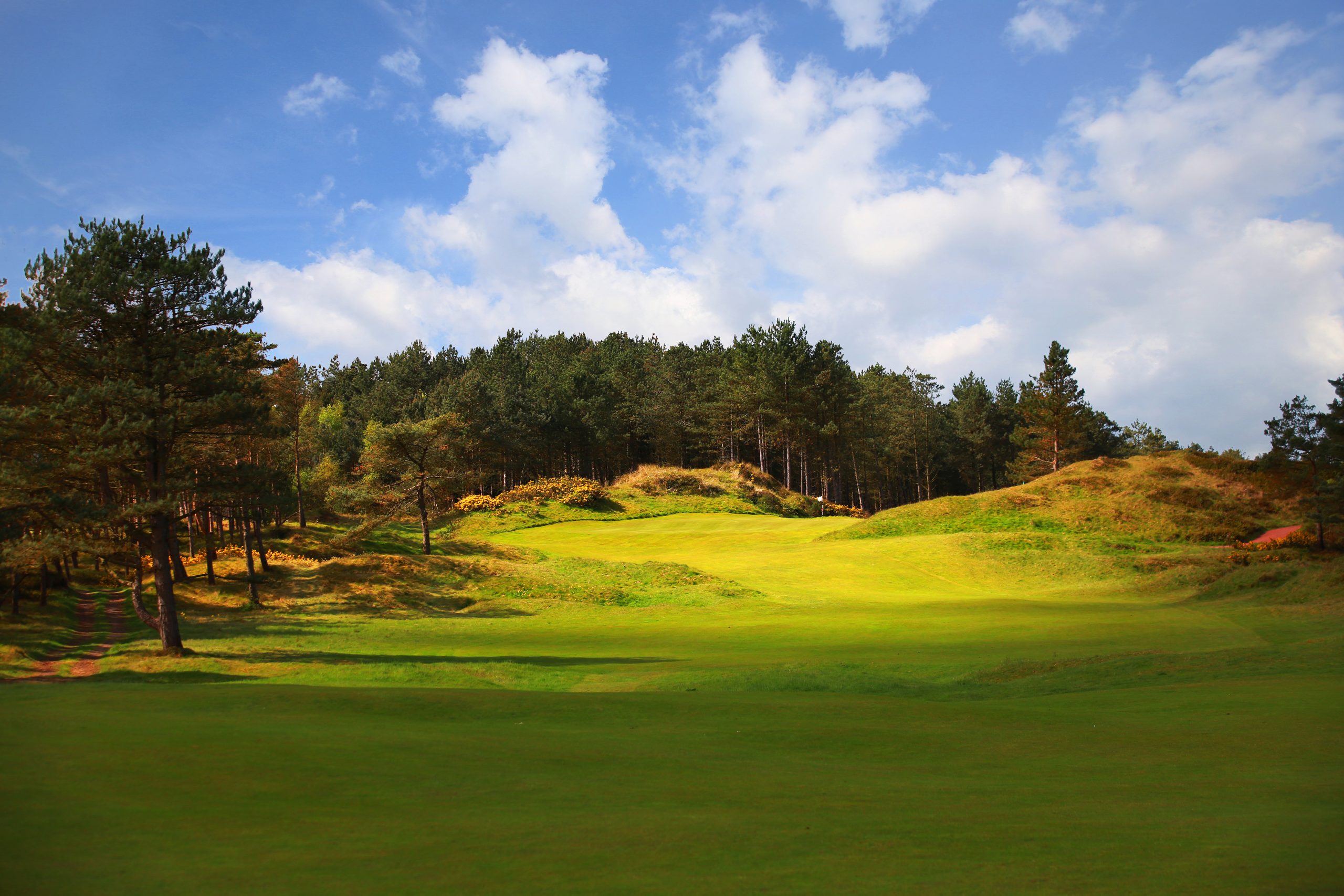 A patch of sunlight lights up the fairway at Formby Golf Club
