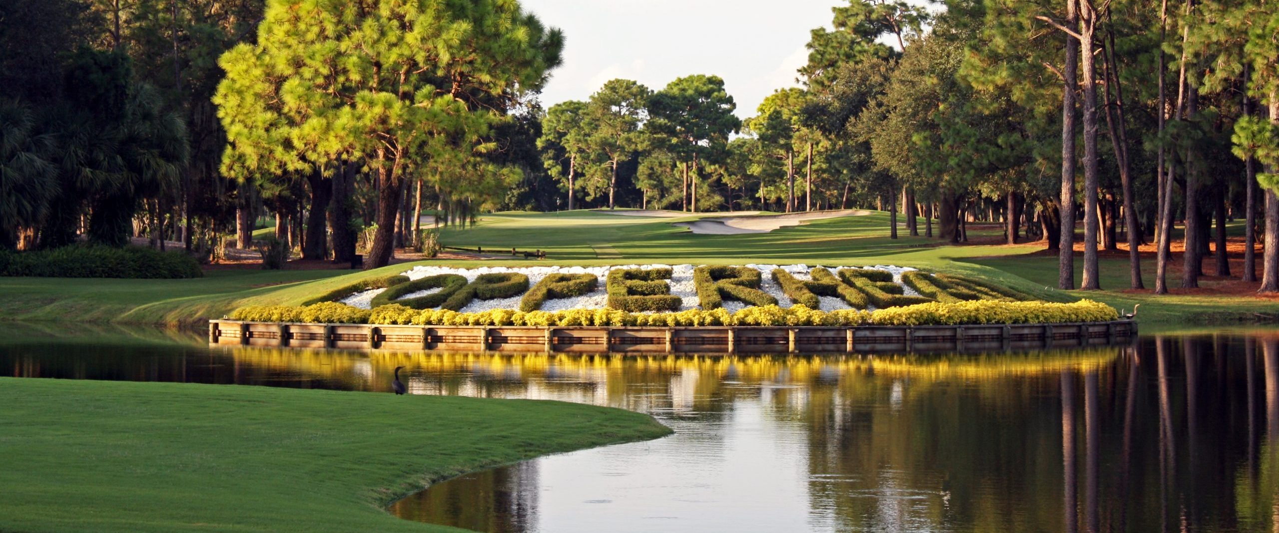 Copperhead Golf Course name in foliage on the side of a lake at Innisbrook golf resort, Florida