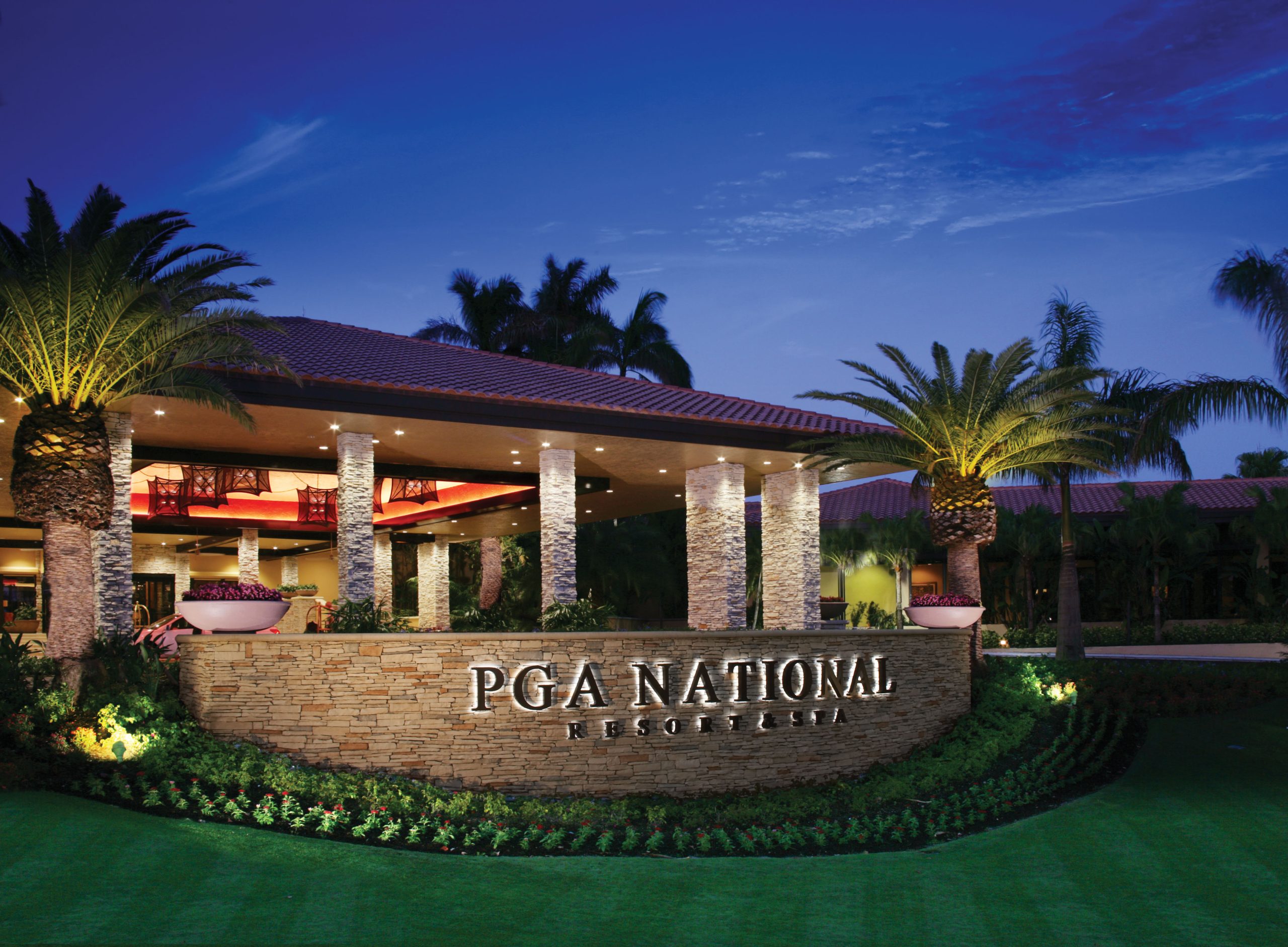 Backlit PGA National sign at night on the entrance to PGA National, Florida