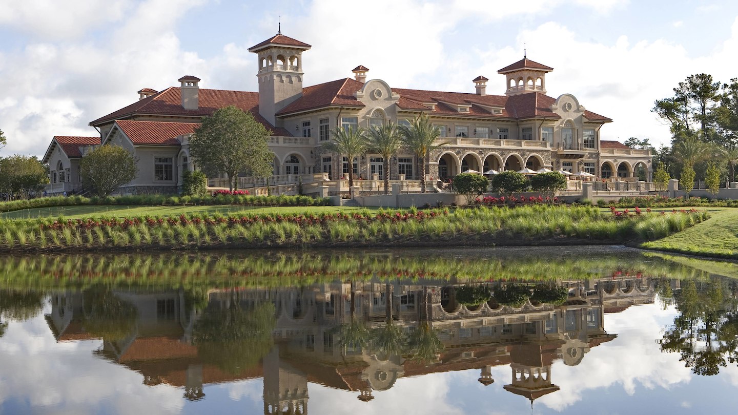 The grand hotel of Sawgrass Marriot Golf Resort reflecting in a lake