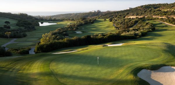 Finca Cortesin golf course green in Spain, with views down the valley over the Mediterranean sea