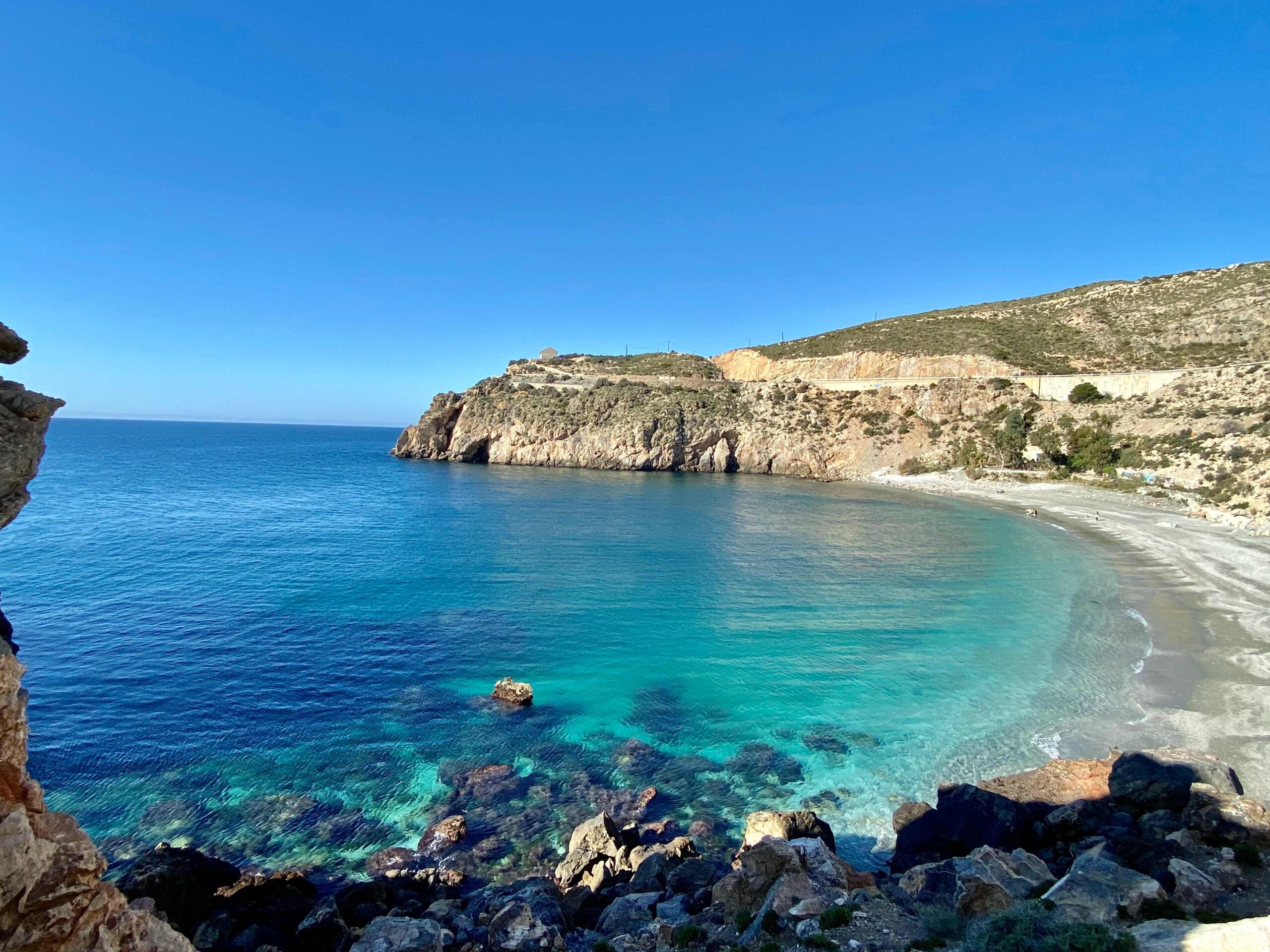 Turquoise blue waters and dramatic cliffs at a beach in Andalucia, Spain